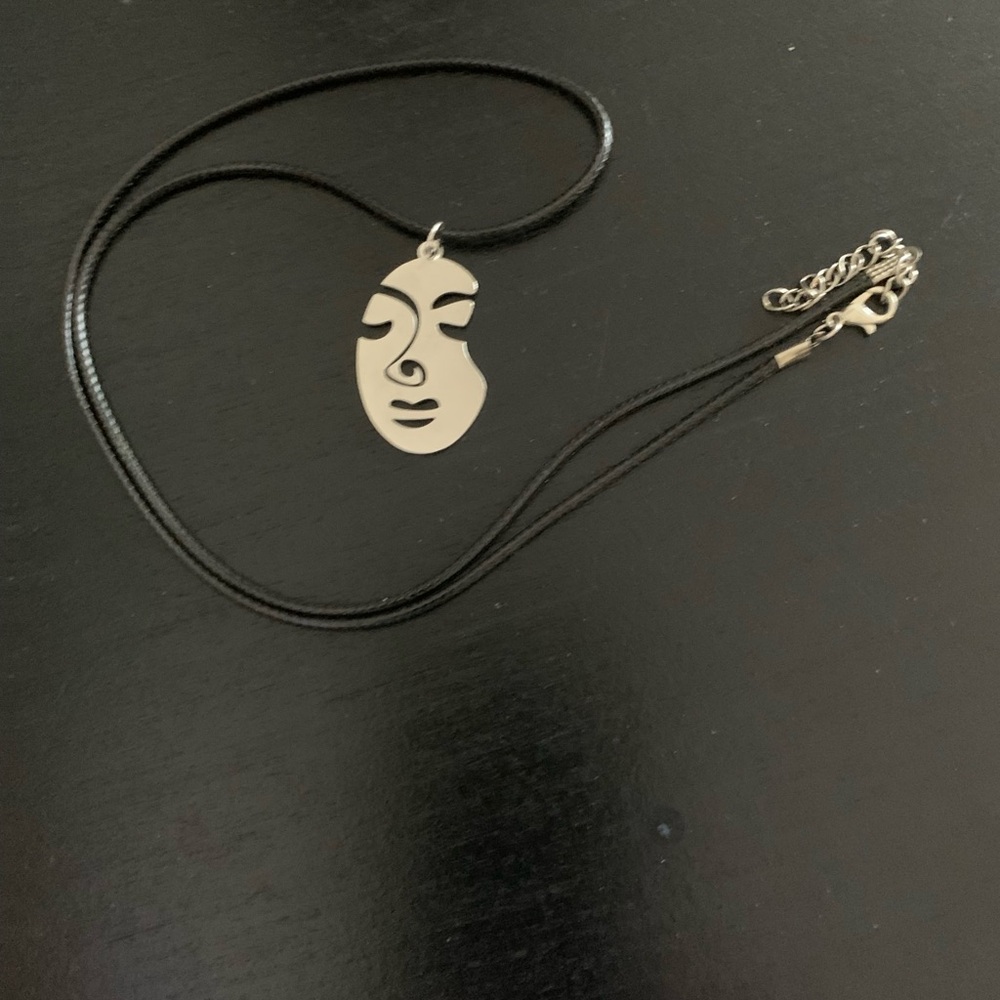 Leather cord with stainless steel face pendant